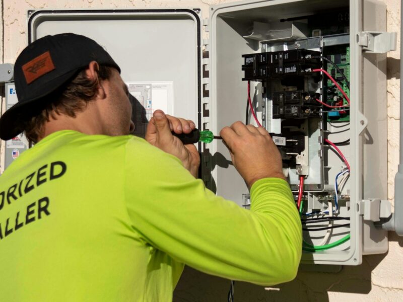 Electrical technician working on a commercial control panel